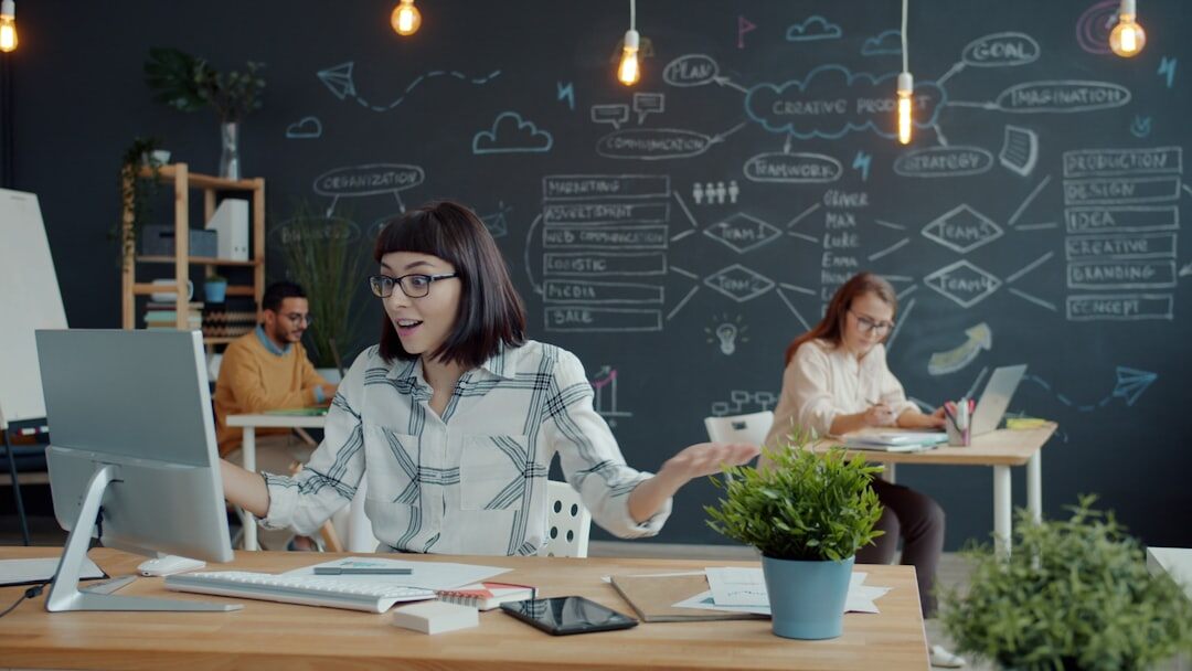 Tech startup team working on laptops in modern office