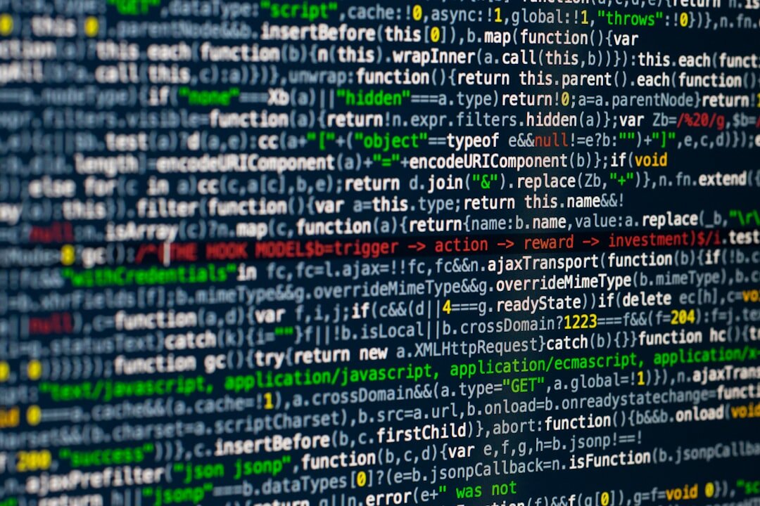 Software developer coding on monitor with colorful code